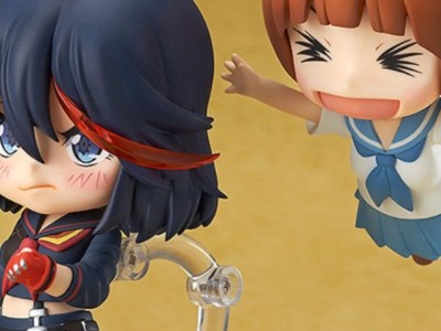 A Nendoroid of Mako leaps into the air to excitedly tackle an annoyed-looking Ryuko.