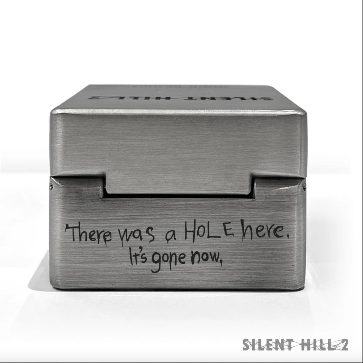 Silent Hill 2 metal music box with "There was a hole here. it's gone now" engraving