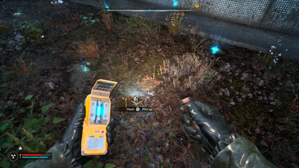 The player finding the Flash artifact with a detector in hand in Stalker 2